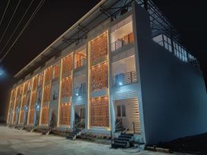 a large building with lit up windows at night at Devaki Resort in Pondicherry