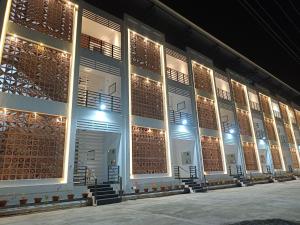 a row of windows in a building at night at Devaki Resort in Pondicherry