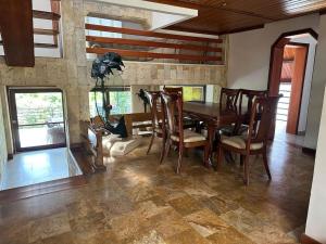 a dining room with a wooden table and chairs at Casa Chalet en Lagos del Cacique in Bucaramanga