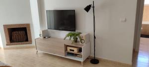a living room with a flat screen tv on a stand at BEACH FOREST PARADISE in Cabopino