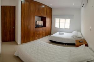 Hotel Casa David في ريفيرا: غرفة نوم بسرير وخزانة خشبية
