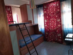 a small room with a bunk bed and a ladder at Vivenda Na Baia das Gatas in Baia das Gatas