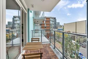 a balcony with two benches and a view of a city at Modern Apt Near Downtown with Parking, AC & GYM in Vancouver