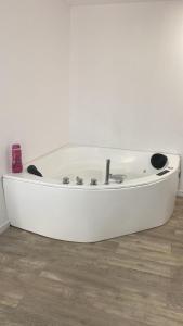 a white bath tub sitting on top of a wooden floor at PLAYA POSTIGUET 2 in Alicante