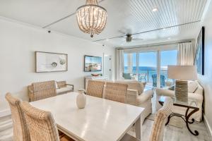 a dining room and living room with a table and chairs at Hp 24w Condo in Rosemary Beach