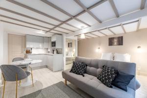 a living room with a couch and a table at Villa Caron - Studios haut de gamme hyper centre in Rouen