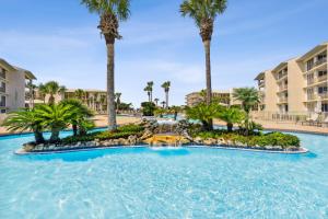 a large pool with palm trees in a resort at Hp 24w Condo in Rosemary Beach