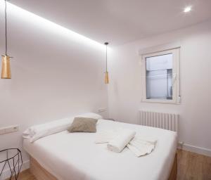 um quarto branco com uma cama branca e uma janela em NEW, Modern and Luxurious, 3BR Apt em Madri