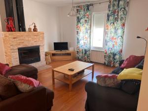 a living room with two couches and a fireplace at Casa Laureana in Ruidera