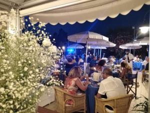 a group of people sitting at tables in a restaurant at Hotel Parco Delle Rose in Silvi Marina +104 photos