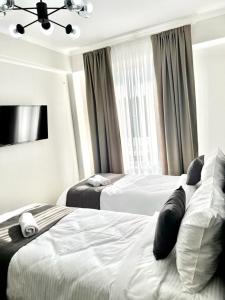 a hotel room with two beds and a window at Urban Hotel in Bishkek