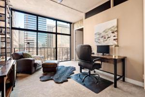 a living room with a desk and a chair at Larimer Square Luxury - Office - Downtown Hub in Denver