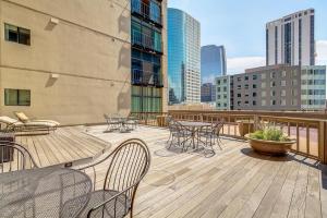 a patio with tables and chairs on a balcony at Larimer Square Luxury - Office - Downtown Hub in Denver