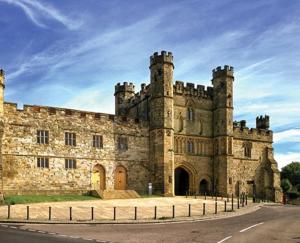 an old stone castle with a fence around it at The Pod in Crowhurst