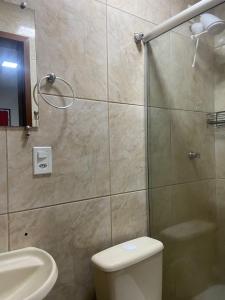 a bathroom with a shower and a toilet and a sink at Pousada Flor De Brasília in Brasilia