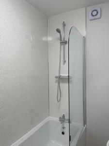 a shower with a glass door in a bathroom at Private En-suite in Birmingham