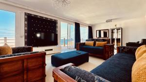 a living room with a couch and a tv at Click&Guest - Blue Marine in Playa del Hombre in Telde