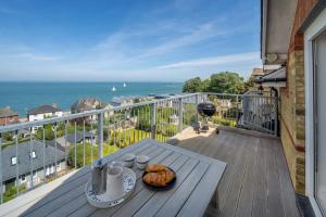 een tafel met een bord eten op een balkon bij Solent View, 3bed apartment, fantastic sea views in West Cowes