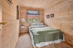 una camera con un letto in una cabina di legno di Koselig hytte nær alpinbakke a Åseral