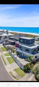 an aerial view of a building next to the beach at Three bedrooms two bathrooms ground floor only not the whole house in Mount Maunganui