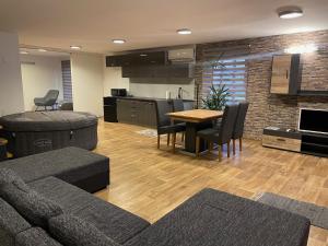 a living room with a couch and a table at Gesztenyés Apartman Mátra Wellness in Parád