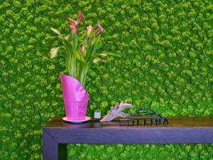 a vase with pink flowers sitting on top of a table at Collina Luxury Relais in Clusone