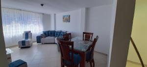 a living room with a table and chairs and a couch at Apartamentos Turisticos EL ZIPA in Zipaquirá