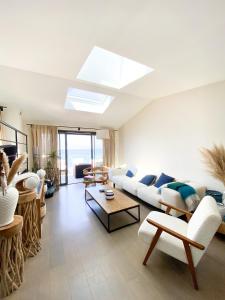 - un salon avec un canapé blanc et une lucarne dans l'établissement Villa luxe vue mer panoramique - sauna-hamam - jacuzzi, à Marseille