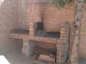 an outdoor brick oven with a brick wall at Departamento El Virula in Villa Unión