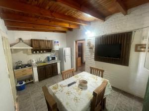 a kitchen with a table and a television in a room at Departamento El Virula in Villa Unión