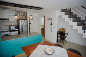 a kitchen with a table and a kitchen with a staircase at Apartamento amoblado tipo loft in Buenos Aires