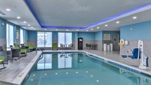 a swimming pool in a hotel room with blue ceilings at Hampton Inn & Suites Keene in Keene