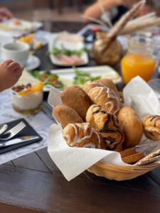 a basket of bread and pastries on a table at La Granja de Antonio in Alhaurín el Grande