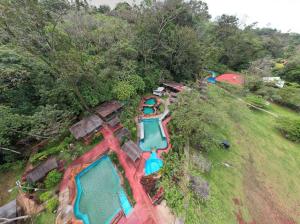 an overhead view of a water park with two pools at BEST PRICE HOUSE in Hot Springs Near La Fortuna in Quesada