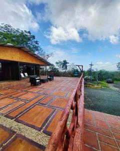 a wooden fence next to a brick patio at BEST PRICE HOUSE in Hot Springs Near La Fortuna in Quesada