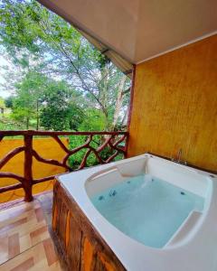 a large bath tub in a room with a window at BEST PRICE HOUSE in Hot Springs Near La Fortuna in Quesada