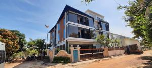 a house with a fence in front of it at NataRiya Villa in Siem Reap