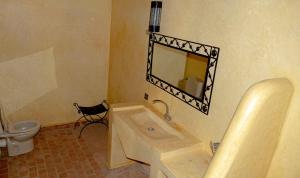 a bathroom with a sink and a mirror and a toilet at JNANE ZOHRA in Taroudant
