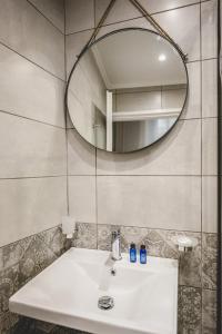 a bathroom with a sink and a mirror at pension Acronafplia ( building C ) in Nafplio