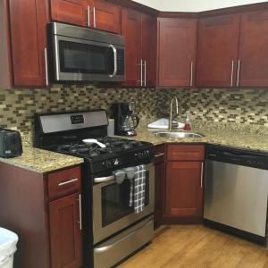 a kitchen with a stove and a microwave at Modern Logan Square 1 bedroom Flat in Chicago