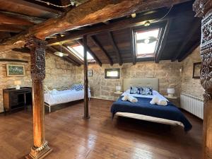 a bedroom with a bed with a blue comforter at Casa Rural Muralla de Haza in Haza