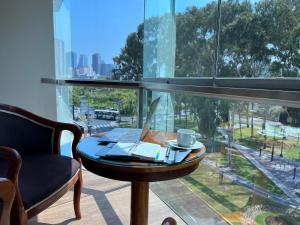 a desk with a laptop on a table in front of a window at 44 VIP Hotel in Lima