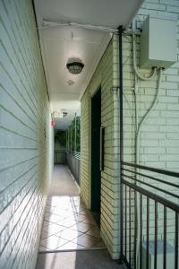 an empty hallway of a building with a green door at French Quarter Suites Hotel in New Orleans