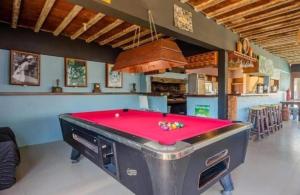 a pool table in the middle of a room at La Quinta Hostel & Suites in Punta del Este