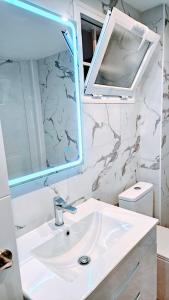 a bathroom with a sink and a mirror at Atlantico Flamingo in Calpe +39 photos
