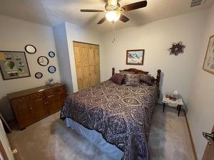 a bedroom with a bed and a ceiling fan at MJSmith Rentals in Ogallala