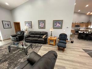 a living room with a leather couch and chairs at MJSmith Rentals in Ogallala