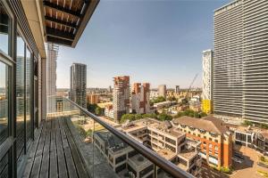 a view of a city from the balcony of a building at Penthouse Canary Wharf - Free WiFi in London