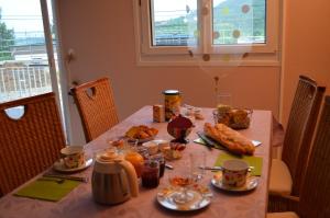 a table with food and drinks on top of it at Chambre d'Hôtes Plesnois in Plesnois