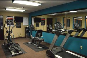 a gym with several cardio machines and a mirror at Baymont by Wyndham Ardmore I-35 in Ardmore